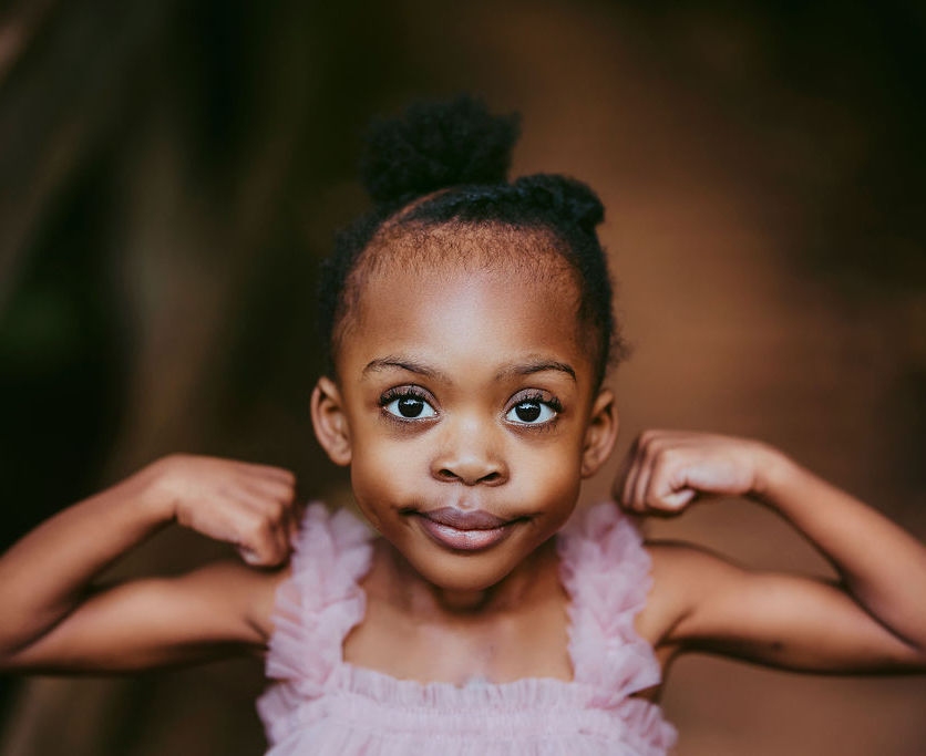 An image of Nyla flexing her muscles. Nyla is the reason for this scholarship.