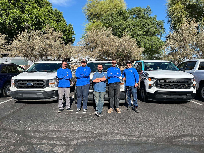 Complete Water Systems Technician Group Photo with Company Trucks