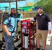 Brian and Damien in front of commercial reverse osmosis system.jpeg
