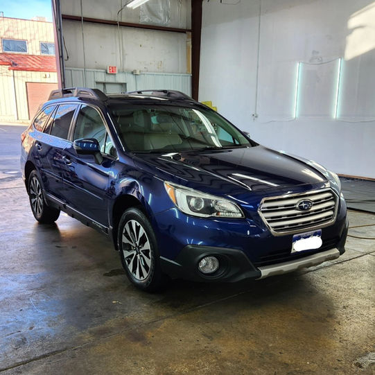 A blue Subaru Outback after our Full Detail package parked in our detail shop in Arvada