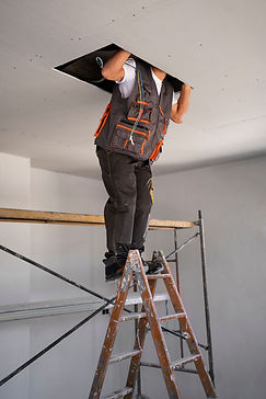 construction-worker-standing-ladder.jpg