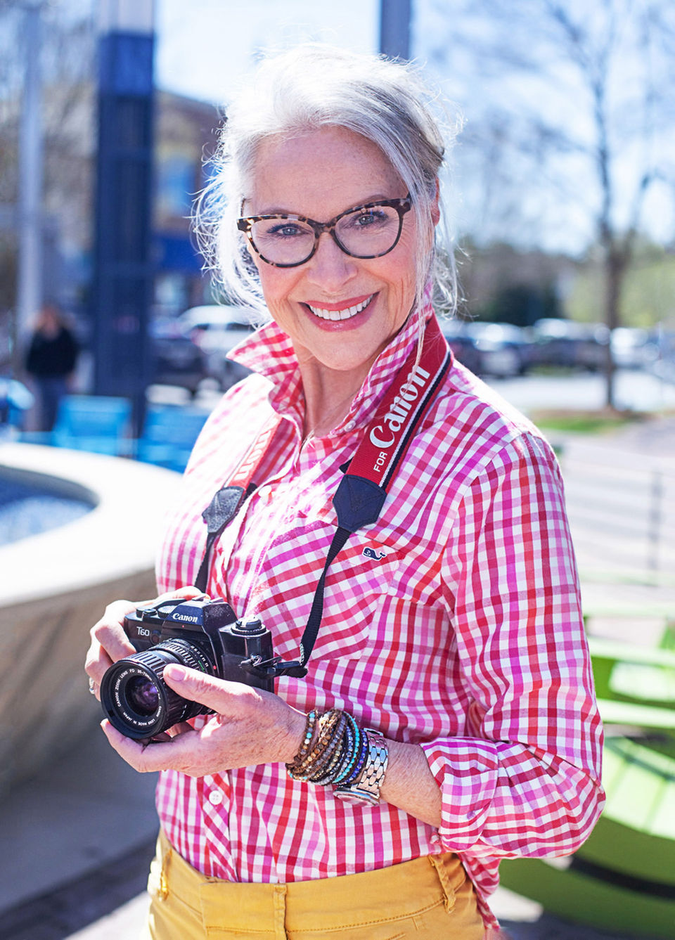 Headshot of a photographer with her camera, picture taken by A Brew and You Headshots, Charlotte, NC 