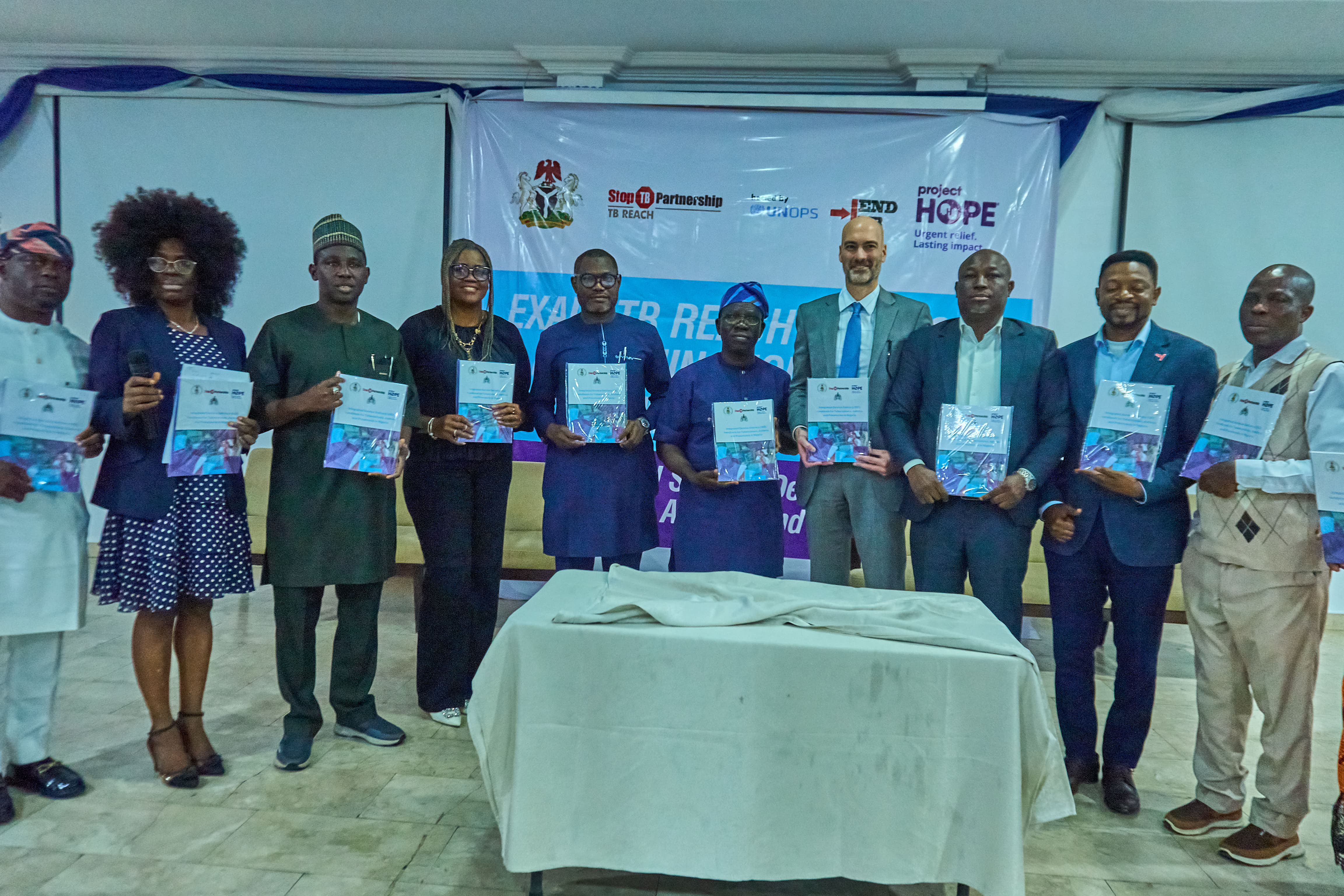 Dignitaries at the EXALT T-REACH Project dissemination event holding the Integrated Lung Health Reference Guideline