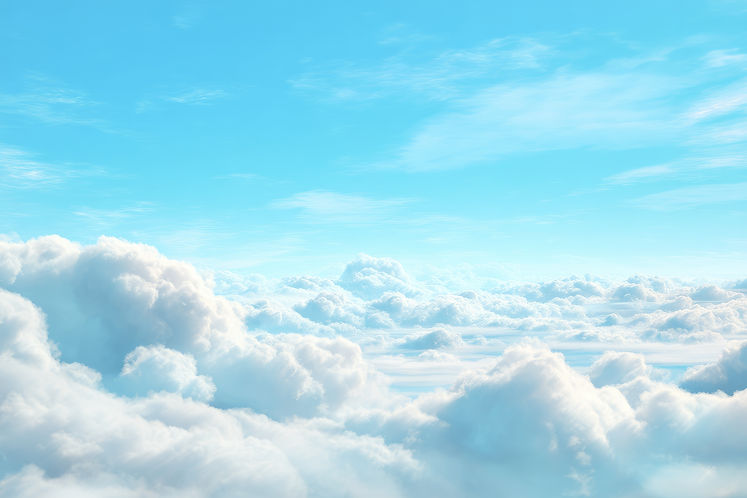 A beautiful aerial view of fluffy white clouds against a backdrop of clear blue sky The cl