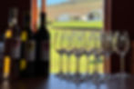 ESSA Wine Co.'s tasting room with bottles of wine and wine glasses