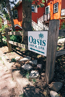 Directional signs leading to Oasis Hair Spa in Oak Creek Marketplace Village, Oak Creek, WI