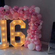 4 foot light up numbers 16 with pink balloon arch and flowers