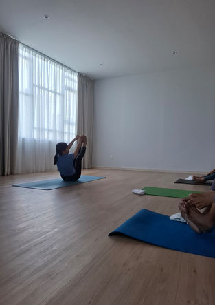 Yoga instructor demonstrating Ashtanga Yoga to her students