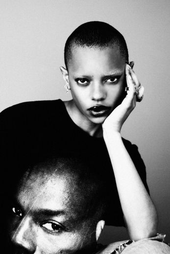 Beautiful bald fashion model Lizette El Pinto staring in the camera in a black and white portrait.