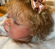 A toddler custom rooted head of hair.