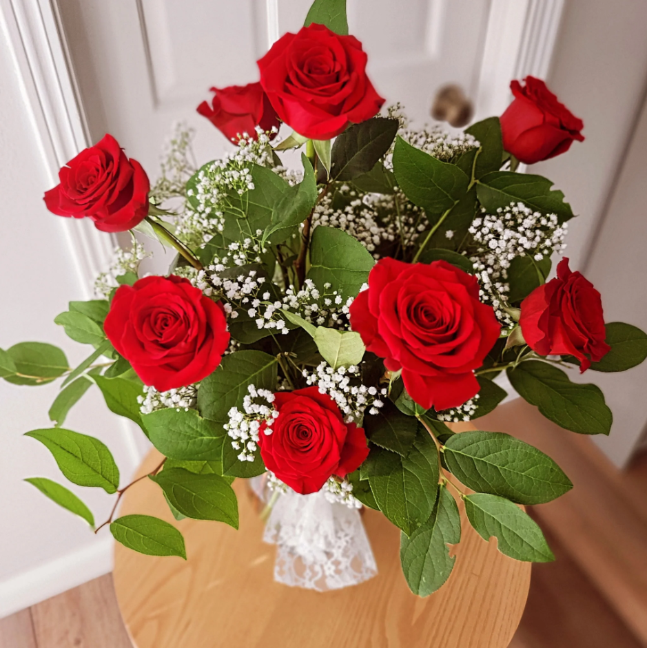 Classic red rose arrangement with baby's breath, ideal for anniversaries or Valentine’s
