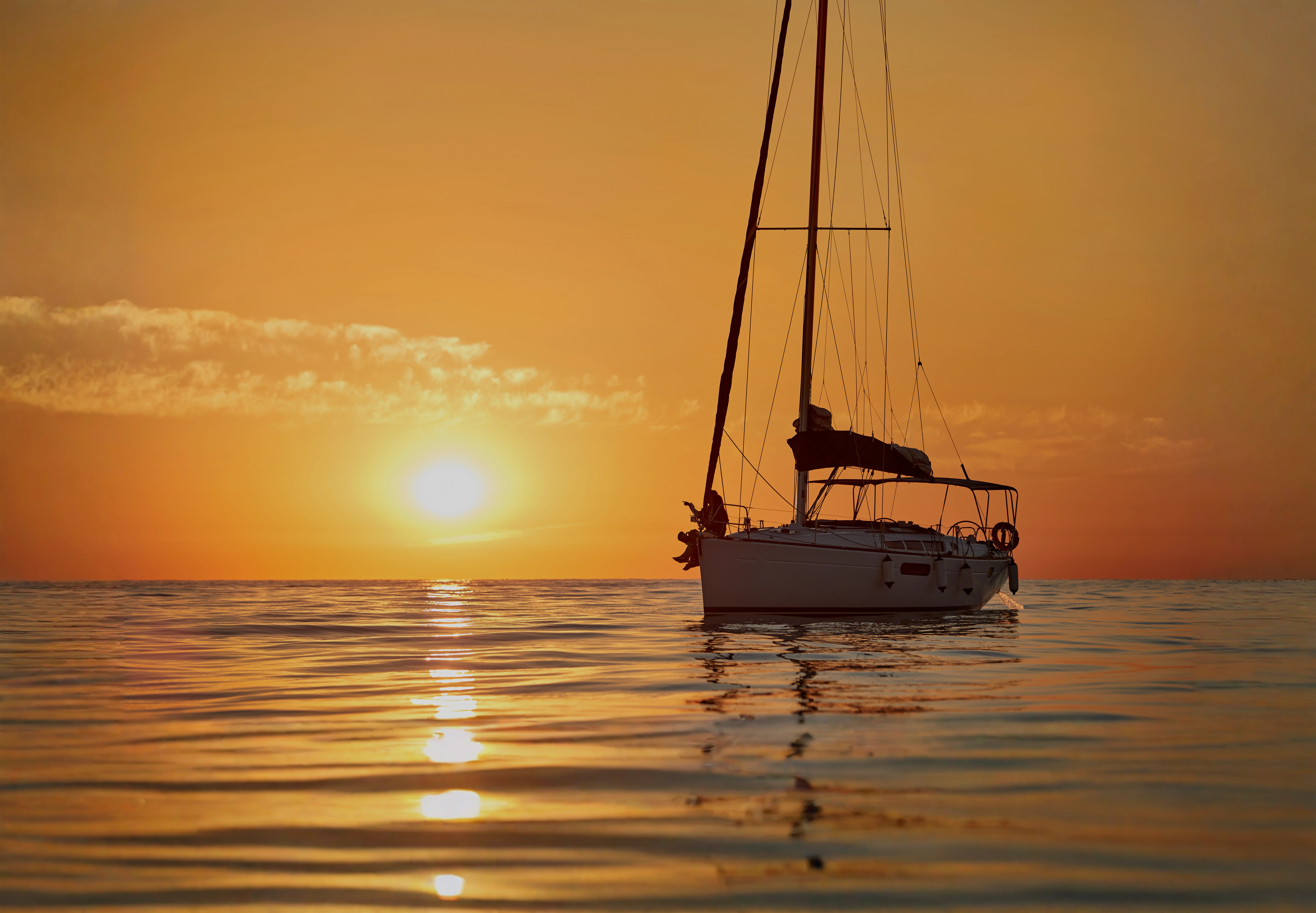 Sailing Flavors sailing experiences with couple aboard a yacht at sunset