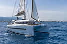 Aerial side view of a Bali 4.1 catamaran sailing with spacious decks visible in the Greek islands