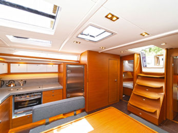 Dufour 470 galley viewed from saloon, showing stove, oven, sink, and ample storage.