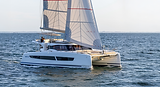Aerial side view of a Fontaine Pajot 41 catamaran heeling gently under sail off the Greek coast