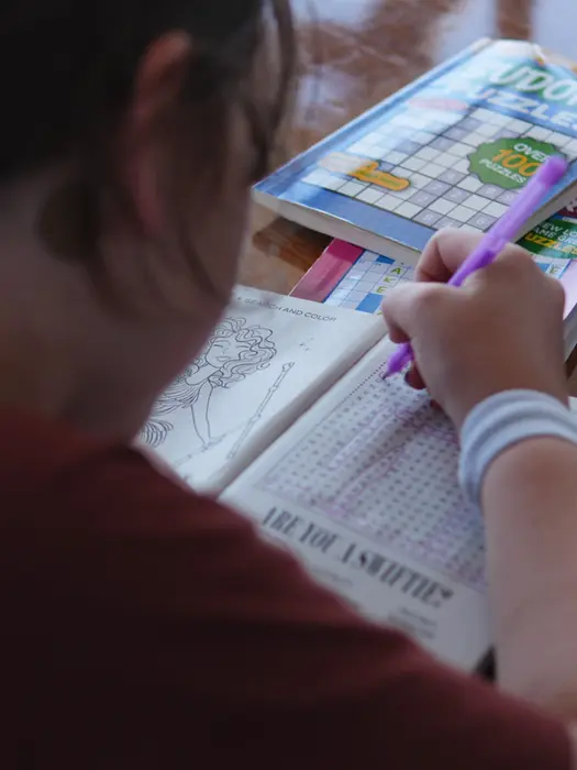 Girl concentrating on a puzzle aboard, cozy Family Holiday moment.