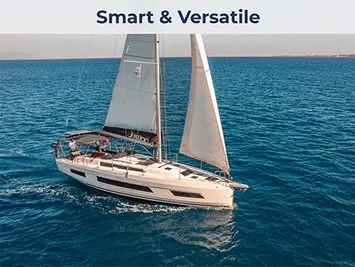 Aerial side view of a Dufour 41 monohull sailing gracefully with white sails against the blue water of the Saronic Gulf.