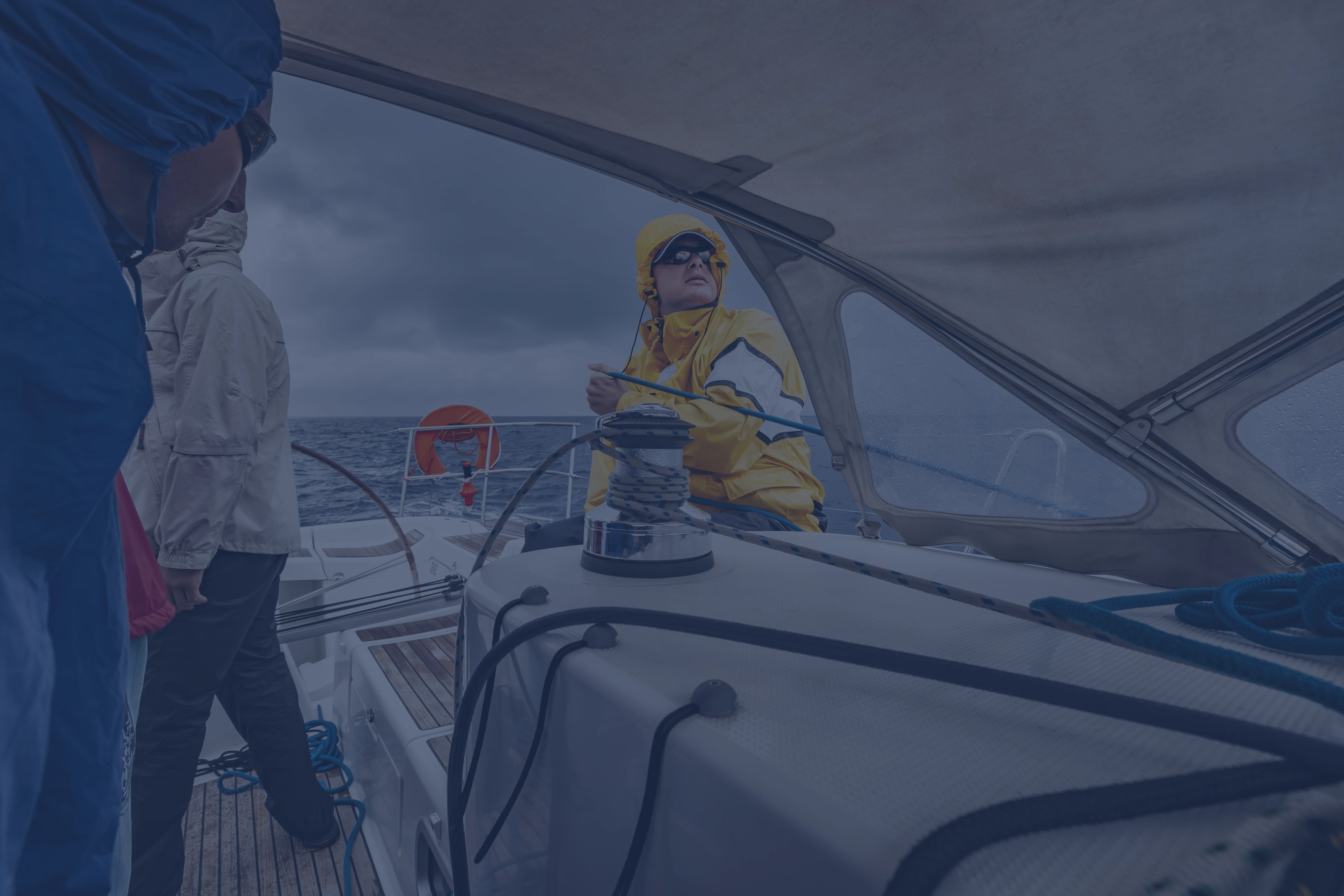 Sailing Flavors sail training with crew member practicing winch handling