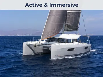 Aerial side view of an Excess 12 performance catamaran sailing with purpose, minimal wake, clear water.