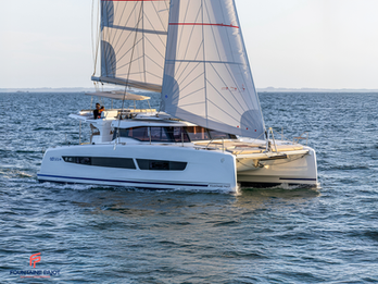 Fountaine Pajot FP41 sailing toward the camera under full sails, aerial forward view, Greek blue waters.