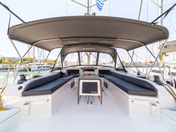 Dufour 530 cockpit viewed from astern, spacious seating with folding dining table.