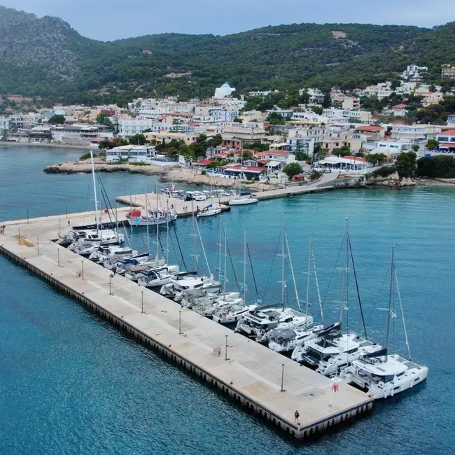 Aerial shot of Agia Marina harbour, Aegina, small fishing boats and a sheltered quay, perfect for anchoring and med mooring drills on Catamaran Confidence course.