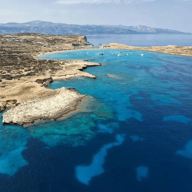 Aerial view of Pori Beach bay with crystal clear turquoise water – one of the stunning stops through the Lesser Cyclades on the Heavy Weather training .