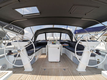 Beneteau Oceanis 46.1 cockpit with twin helm stations, spacious seating, and central folding table.