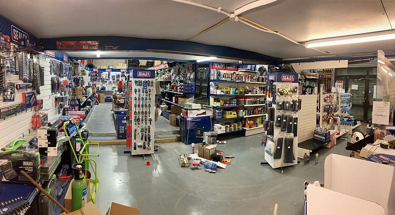 Interior of a hardware store showing aisles of Sealey tools, car parts and various accessories