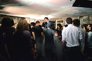 A lively underground concert features a singer at a microphone