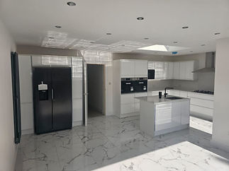 Spacious modern kitchen with glossy white cabinets, marble floor
