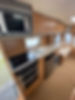 Interior of a cozy caravan kitchen featuring wooden cabinets