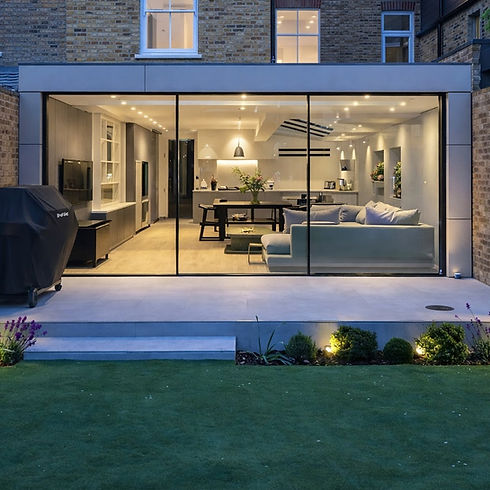 Modern open-plan home extension featuring a massive wall of sliding glass doors