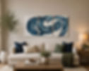 Modern living room featuring a triptych of blue abstract art above a cream sofa