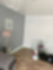 A room being painted with a grey feature wall, white adjoining wall