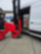 Forklift loading boxes into a white van parked on a concrete surface