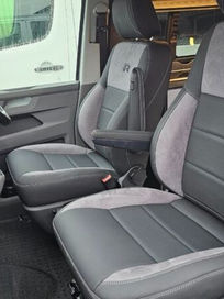Front cabin of a camper van showing matching premium black