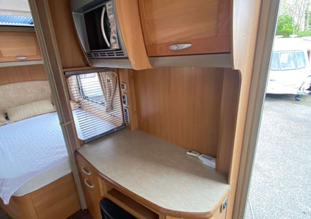 Caravan side dresser with a built-in microwave and space for a television