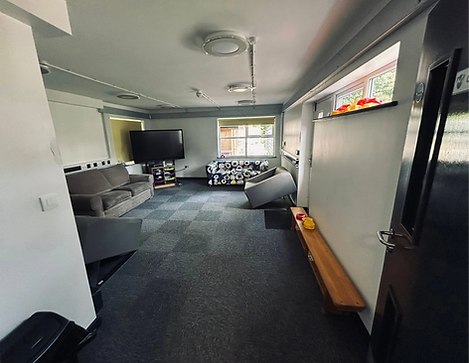 Staged living space featuring sofas coffee table and grey armchair