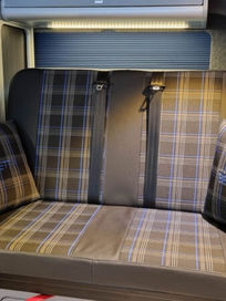 Luxury tartan campervan bench seat with matching fabric scatter cushions and blue blinds