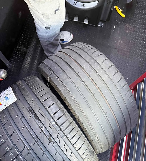 Two car tires are compared; one is worn and the other has deep treads