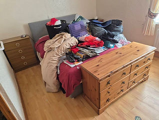 A bedroom with house removal items