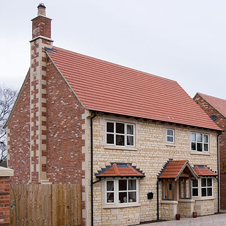New built, two-story brick houses with red-tiled roofs