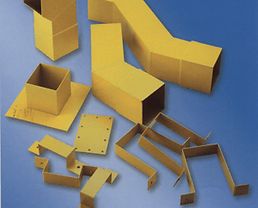 Various yellow PVC downpipe components and mounting brackets arranged on a blue surface