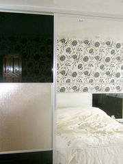 A modern bedroom with sliding wardrobe doors