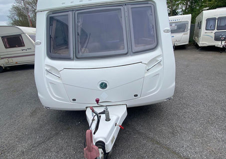 Front view of a white Bessacarr caravan showing the hitch and large windows