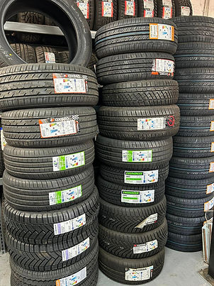 Stacks of new tyres displayed with EU tyre labelling stickers showing ratings