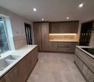 Modern kitchen with wood cabinets and beige tile flooring