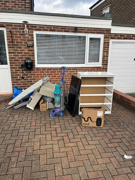 Household items including an ironing board, vacuum cleaner, TV