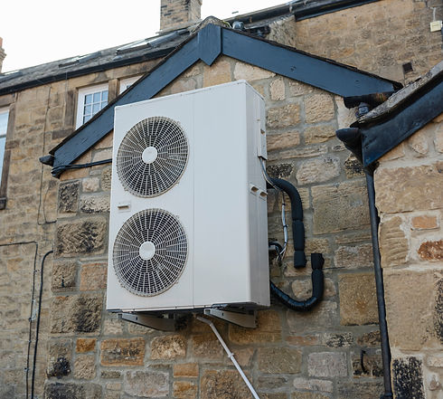 An air source heat pump on the side of a home